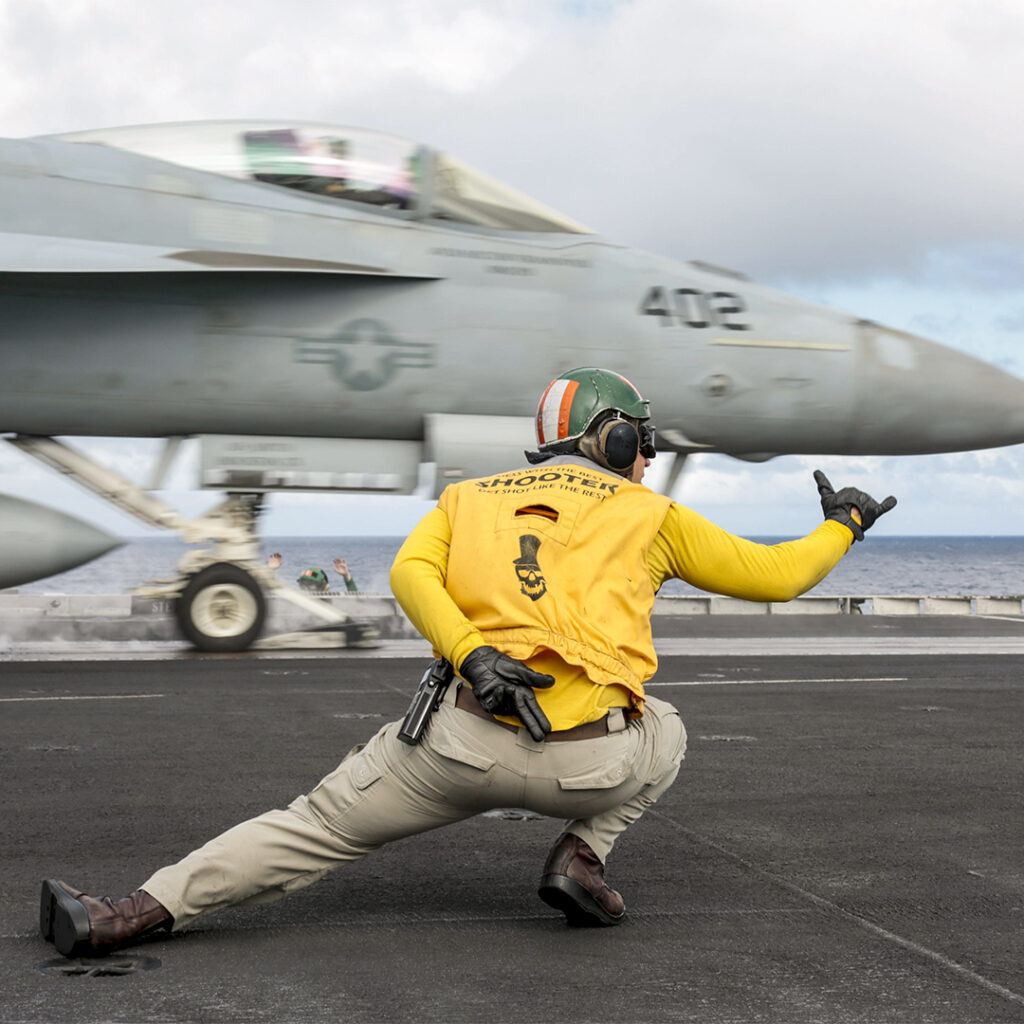 191228-N-MM912-1147
PHILIPPINE SEA (Dec. 28, 2019) Lt. Charles Kollar directs the launch of an F/A-18E Super Hornet attached to the Fist of the Fleet of Strike Fighter Squadron (VFA) 25 on the flight deck of the aircraft carrier USS Abraham Lincoln (CVN 72). The Abraham Lincoln Carrier Strike Group is deployed to the U.S. 7th Fleet area of operations in support of security and stability in the Indo-Pacific region. With Abraham Lincoln as the flagship, deployed strike group assets include staffs and aircraft of Carrier Strike Group (CSG) 12, Destroyer Squadron (DESRON) 2 and Carrier Air Wing (CVW) 7. (U.S. Navy photo by Mass Communication Specialist 3rd Class Michael Singley/Released)