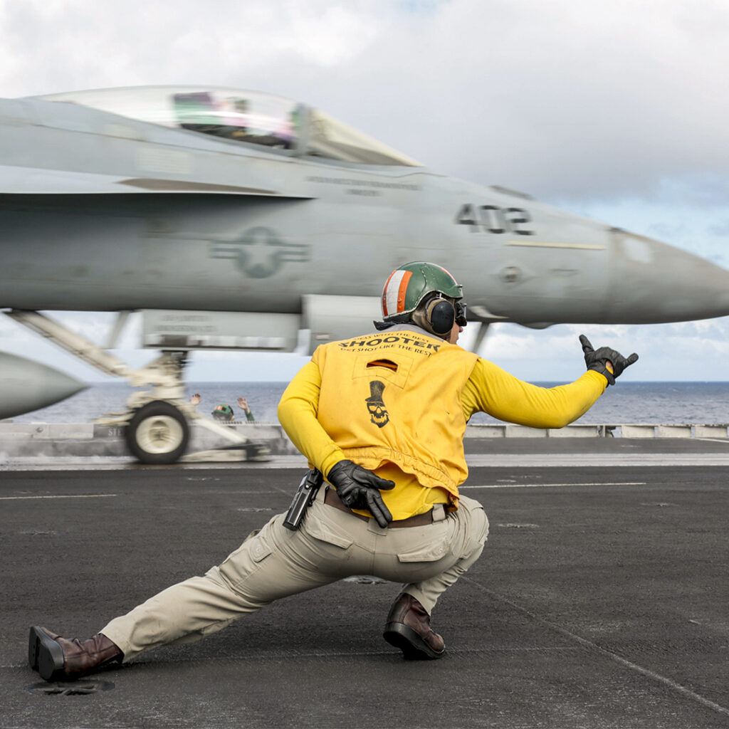 Flight operations. 191228-N-MM912-1147
PHILIPPINE SEA (Dec. 28, 2019) Lt. Charles Kollar directs the launch of an F/A-18E Super Hornet attached to the Fist of the Fleet of Strike Fighter Squadron (VFA) 25 on the flight deck of the aircraft carrier USS Abraham Lincoln (CVN 72). The Abraham Lincoln Carrier Strike Group is deployed to the U.S. 7th Fleet area of operations in support of security and stability in the Indo-Pacific region. With Abraham Lincoln as the flagship, deployed strike group assets include staffs and aircraft of Carrier Strike Group (CSG) 12, Destroyer Squadron (DESRON) 2 and Carrier Air Wing (CVW) 7. (U.S. Navy photo by Mass Communication Specialist 3rd Class Michael Singley/Released)