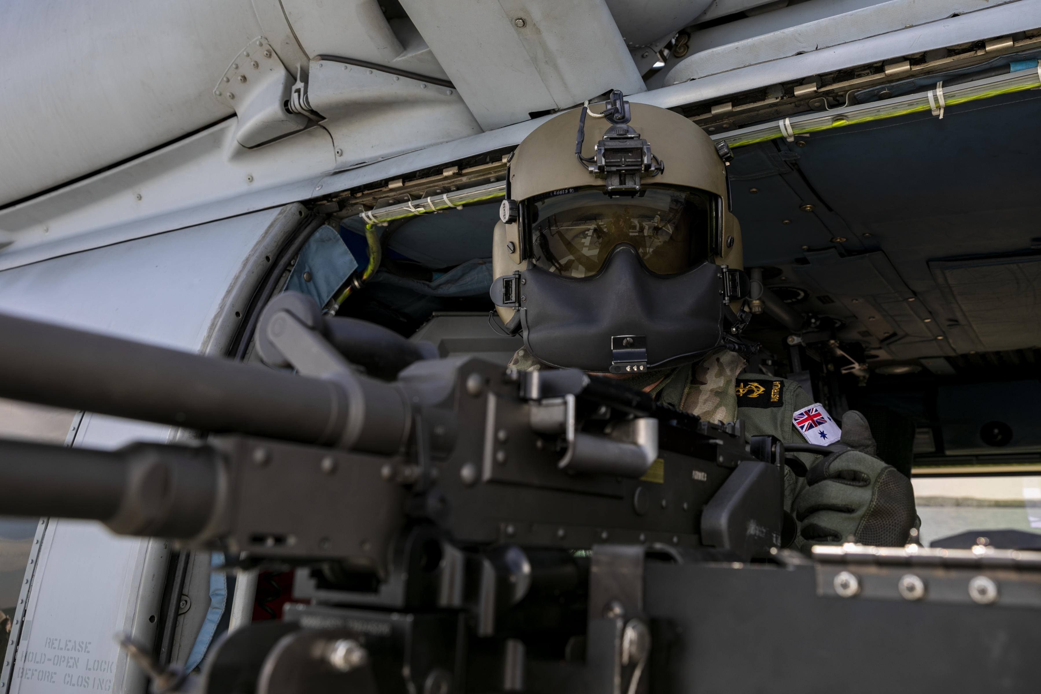 Leading Seaman Aircrew Michael Sales conducts pre-flight inspections of a Mag 58 machine gun on the Seahawk MH-60R helicopter embarked on HMAS Parramatta.