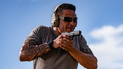 Man wearing hearing protection with gun